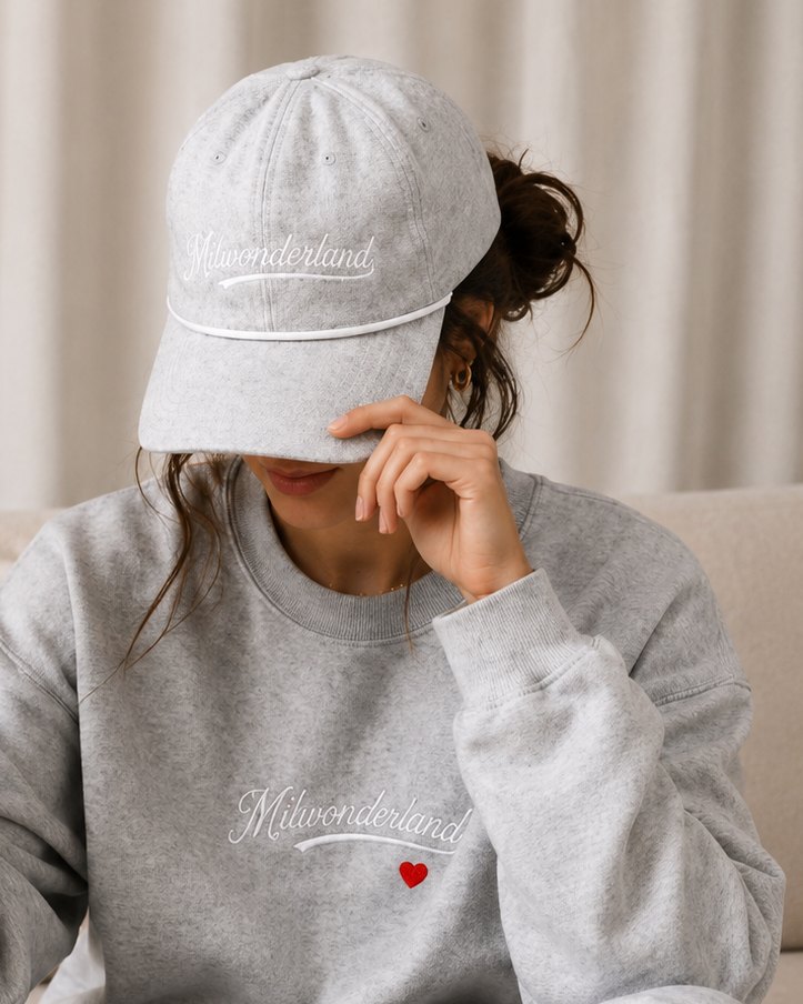 The light grey rope cap worn, white script and white braid.