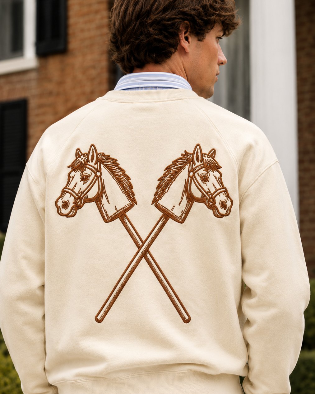 The back of the bone crewneck: the crossed hobby horses in tawny.