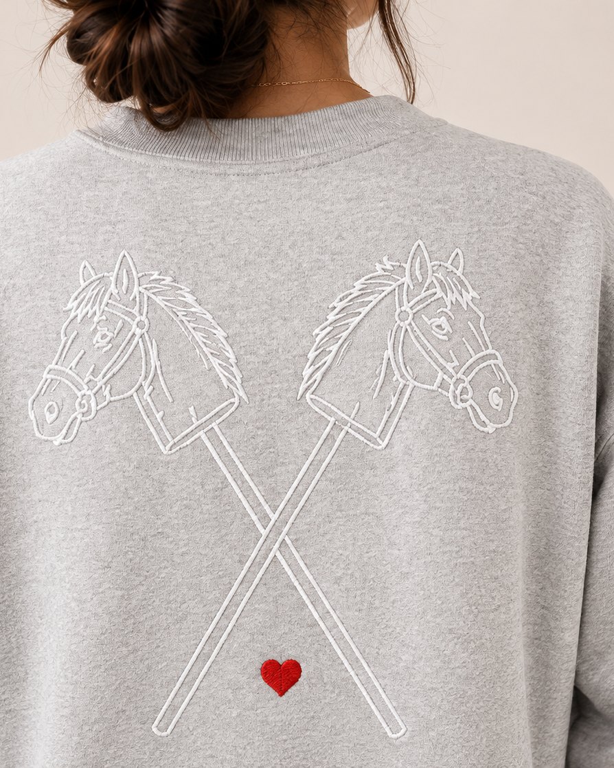 The back of the grey crewneck: the crossed hobby horses in white.